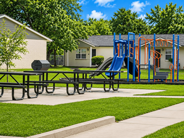Alexandria apartment for rent - A playground with a blue slide and picnic table.