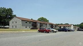 Richmond apartment for rent - A parking lot with cars and a building in the background.