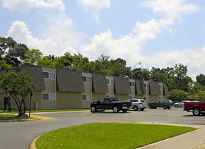 Baton Rouge townhouse for rent - A black truck is parked in a parking lot in front of a building.