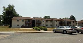 Richmond apartment for rent - A car is parked in front of a building with a parking lot.