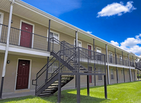 Baton Rouge townhouse for rent - A building with a red door and a black metal staircase.