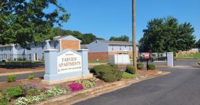 Thomaston apartment for rent - an exterior view of a property with a sign apartments