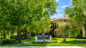 The Woodlands apartment for rent - A sign that says "Fawne Ridge" in front of a house.