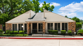 The Woodlands apartment for rent - A house with a red brick facade and a grey roof.
