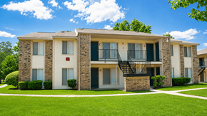 The Woodlands apartment for rent - Apartment building with a green lawn in front.