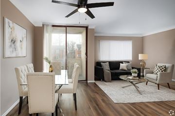 St. Louis apartment for rent - A living room with a dining table and chairs.