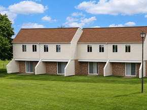 Kenton apartment for rent - A white building with a brown roof and a green lawn in front.