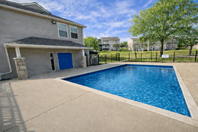 Kansas City apartment for rent - A residential house with a blue door and a pool in the backyard.