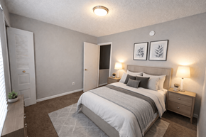Kansas City apartment for rent - A bedroom with a bed, nightstands, and a window.