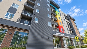 Denver apartment for rent - A multi-story building with a Community Living sign on the front.