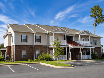 Nashville apartment for rent - A large two-story apartment building with a parking lot in front.