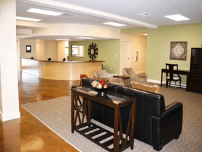 New Orleans apartment for rent - A living room with a black leather couch and a wooden coffee table.