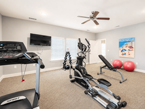 Nashville apartment for rent - A home gym with a treadmill, exercise bike, and weights.