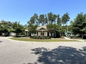 Clinton apartment for rent - a house on the corner of a roundabout in front of some trees