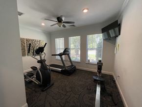 Clinton apartment for rent - a home gym with exercise equipment and a ceiling fan