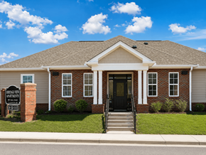 Montgomery apartment for rent - A brick building with a black door and a sign in front.