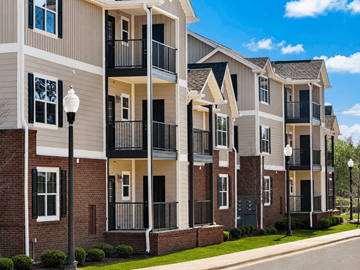 Montgomery apartment for rent - A row of modern apartment buildings with balconies and black railings.