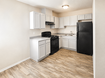 El Paso apartment for rent - A kitchen with black appliances and white cabinets.