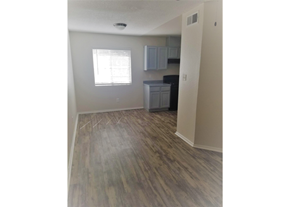El Paso apartment for rent - an empty living room with wood floors and a kitchen