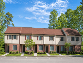 Hopewell townhouse for rent - Apartment building with a parking lot in front.