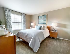 Arnold apartment for rent - a bedroom with a bed and two nightstands and a window