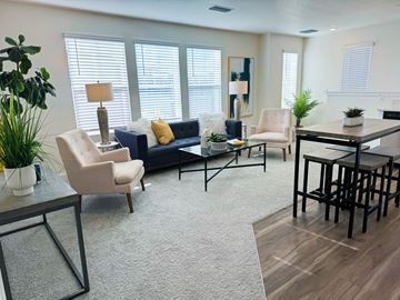Denver apartment for rent - a living room with a couch and chairs and a table