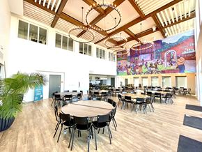 Denver apartment for rent - a large dining room with tables and chairs and a mural on the wall