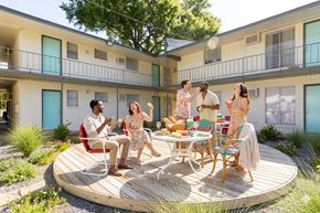 Memphis apartment for rent - A group of people are gathered around a table on a wooden deck.