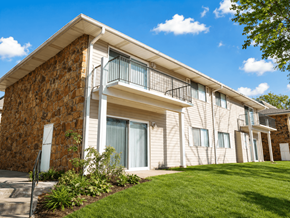 Broken Arrow townhouse for rent - A building with a balcony and a stone wall.