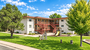 Lakewood apartment for rent - A white building with a red staircase in front of it.