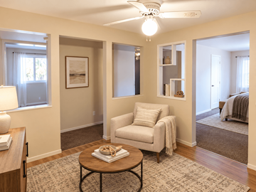 Lakewood apartment for rent - A living room with a white chair and a coffee table.