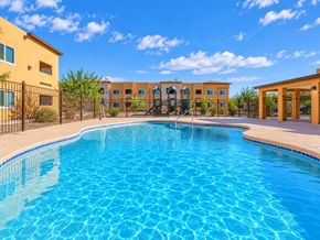 El Paso apartment for rent - A swimming pool in front of a building with a fence around it.