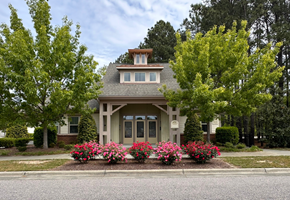 Knightdale apartment for rent - the front of a house with flowers in front of it