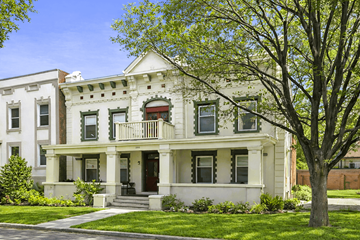Denver apartment for rent - A white two-story house with a red door and a balcony.