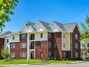 Memphis apartment for rent - A large red brick apartment building with a white trim and a black roof.