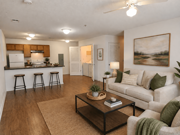 Memphis apartment for rent - A living room with a white couch, a coffee table, and a painting on the wall.