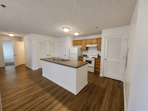 Memphis apartment for rent - A kitchen with white cabinets and a wooden floor.