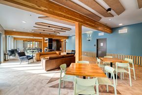 Aurora apartment for rent - A modern living room with a wooden ceiling and furniture.