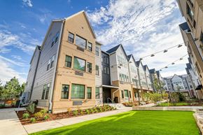 Aurora apartment for rent - A modern apartment complex with a well-maintained lawn in front.