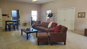Socorro townhouse for rent - A living room with a brown couch and a coffee table.