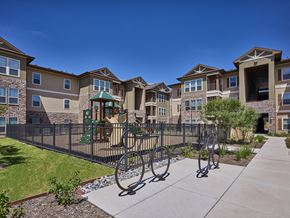 Edinburg apartment for rent - A row of houses with a playground in the foreground.