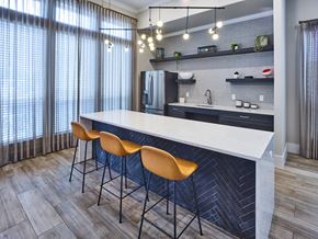 Edinburg apartment for rent - A kitchen with a bar area and chairs.