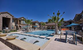 Edinburg apartment for rent - A pool with a slide and a palm tree in the foreground.