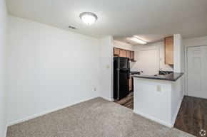 Hampton apartment for rent - A kitchen area with a black refrigerator and a white countertop.