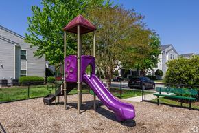 Hampton apartment for rent - A purple slide in a playground with a red roof.