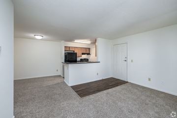Hampton apartment for rent - A spacious living room with a television and a bar area.