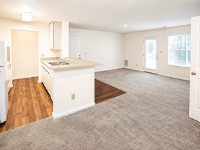 Chesapeake apartment for rent - A kitchen with white appliances and a white island with a sink.
