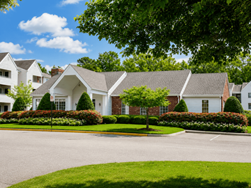 Chesapeake apartment for rent - A large white house with a grey roof and a green lawn in front.