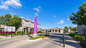 Socorro townhouse for rent - The image shows a gated entrance to a residential area named "Mission Pass" with a purple flag in the foreground.