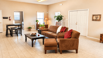 Socorro townhouse for rent - A living room with a brown couch and a coffee table.